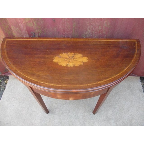 204 - A 19th century mahogany and marquetry demi lune tea table with foldover top, raised on square, taper... 