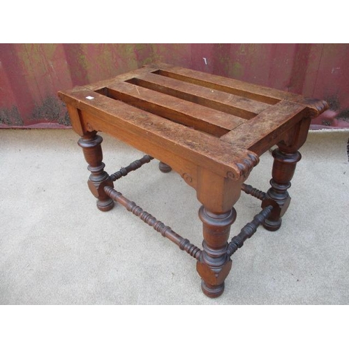 205 - A Victorian walnut luggage stand with a slatted top, raised on turned, block legs, united by stretch... 