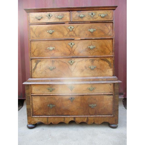 206 - An early 18th century walnut chest on stand having a quarter veneered, crossbanded top over two shor... 