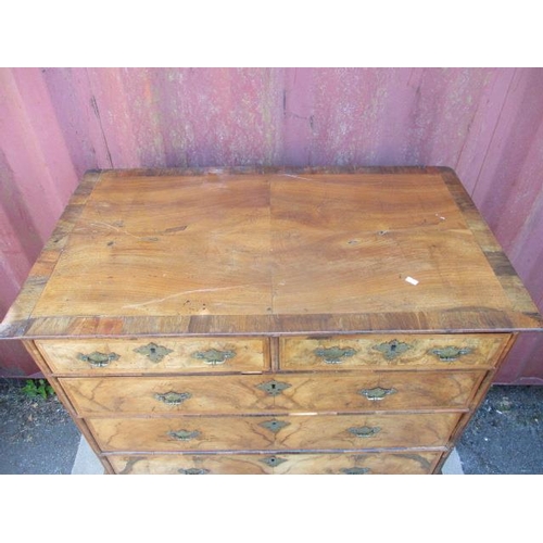 206 - An early 18th century walnut chest on stand having a quarter veneered, crossbanded top over two shor... 