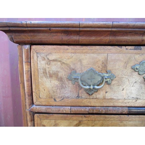 206 - An early 18th century walnut chest on stand having a quarter veneered, crossbanded top over two shor... 