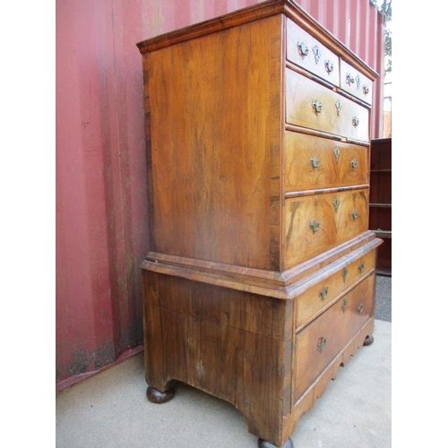 206 - An early 18th century walnut chest on stand having a quarter veneered, crossbanded top over two shor... 