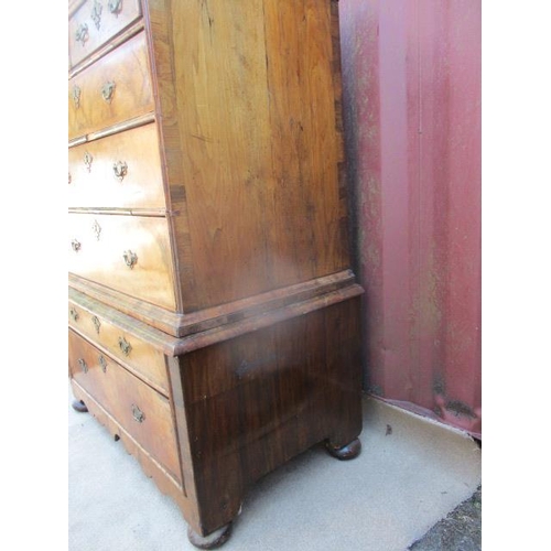 206 - An early 18th century walnut chest on stand having a quarter veneered, crossbanded top over two shor... 