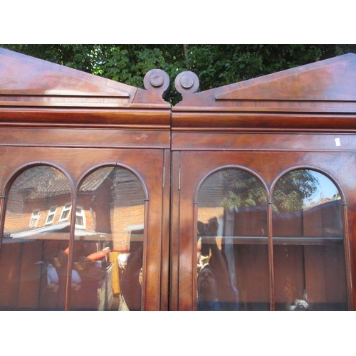 209 - A Victorian mahogany reduced bookcase cabinet having a double arched cornice, over four glazed, pane... 