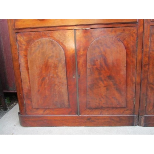 209 - A Victorian mahogany reduced bookcase cabinet having a double arched cornice, over four glazed, pane... 