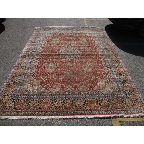 212 - An Indian cotton carpet with a central medallion, palmets, flowing branches and flowers on a red gro... 