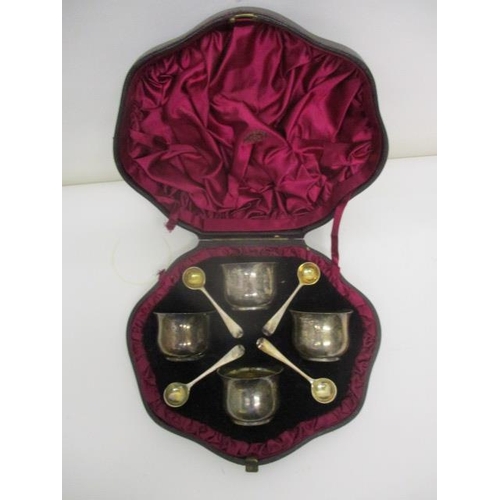 224 - A set of four silver salts of cut form with gilt interiors and four matching spoons, by Henry John L... 