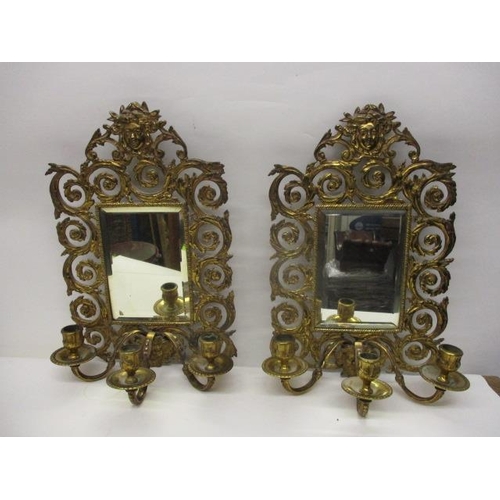 273 - A pair of late 19th century brass girandoles with a bevelled rectangular plate in a floral, scrolled... 