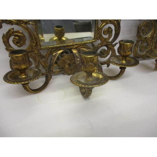 273 - A pair of late 19th century brass girandoles with a bevelled rectangular plate in a floral, scrolled... 