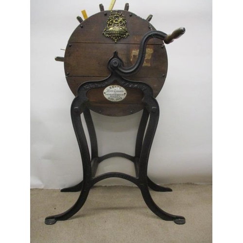 276 - A Victorian Kent's oak cased knife cleaner on a cast iron stand with splayed legs, 42