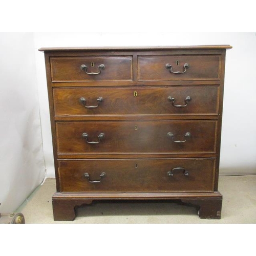 277 - A George III mahogany chest of two short and three graduated long drawers with feather crossbanding,... 