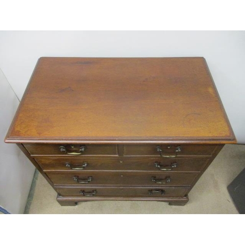 277 - A George III mahogany chest of two short and three graduated long drawers with feather crossbanding,... 