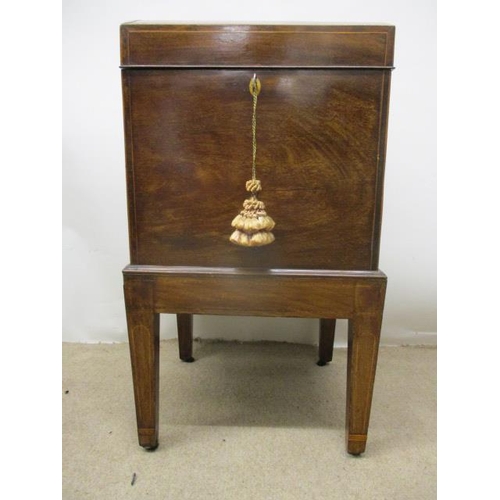 278 - A George III boxwood, string inlaid mahogany cellerette having a hinged, arched top over straight si... 