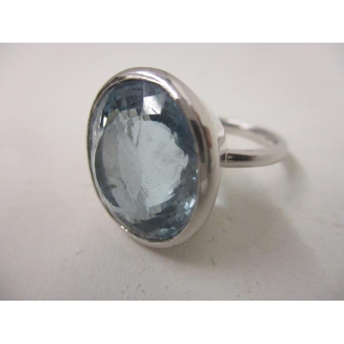 282 - An 18ct white gold ring set with a topaz in a rub-over setting