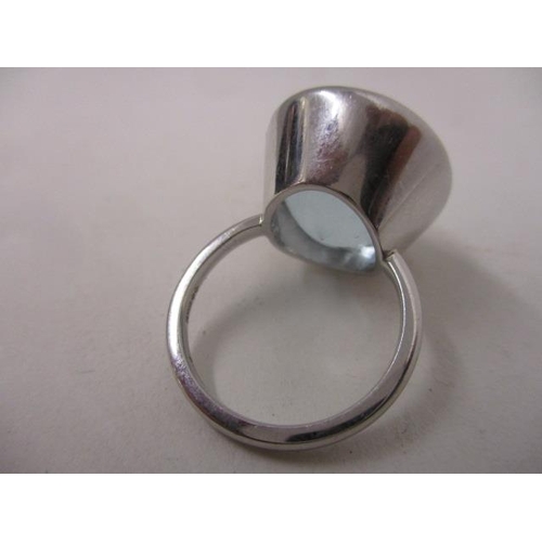 282 - An 18ct white gold ring set with a topaz in a rub-over setting