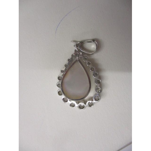 242 - A platinum pendant with a suspended teardrop peal and set with twenty diamonds, approximately 1ct