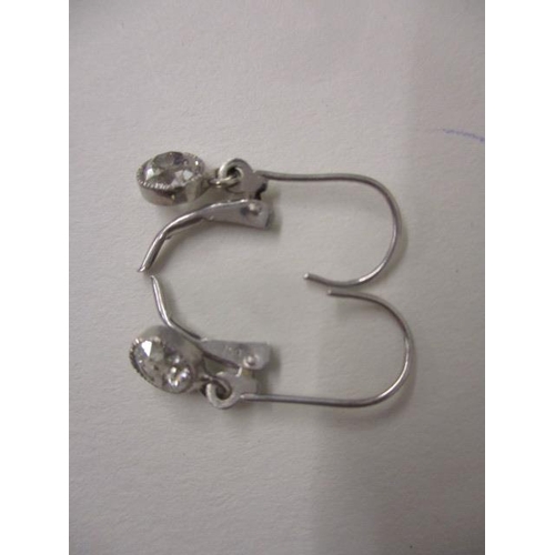 243 - A pair of 18ct white gold and diamond pendant earrings, approximately 0.33ct each