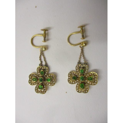 237 - A pair of 9ct gold earrings, each fashioned as a four leaf clover, set with seed pearls and green st... 