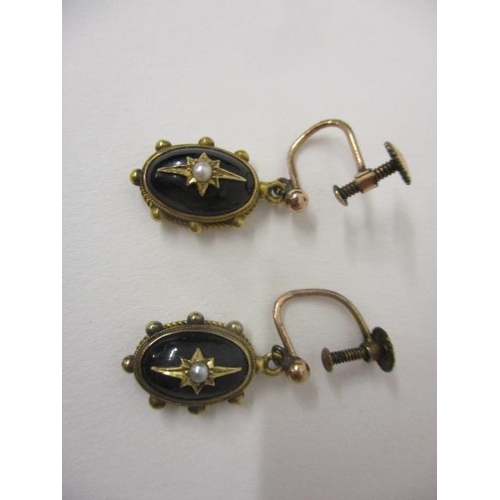 238 - A pair of gold coloured metal and black enamelled earrings of domed form set with a seed pearl, on s... 