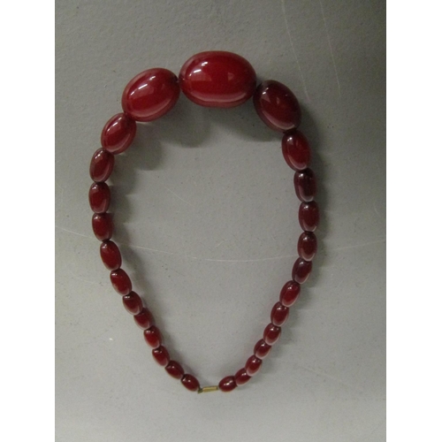 270 - A phenolic Bakelite, cherry red, graduated bead necklace, 21.58g