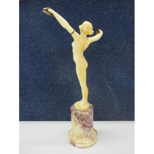 303 - Louis Sosson - 'Danseuse aux Cymbales' a carved ivory figurine of a woman with outstretched arms hol... 