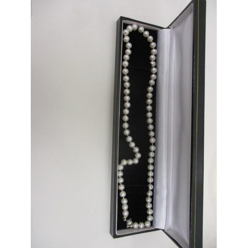 240 - A single strand pearl necklace with an 18ct white gold, ball clasp