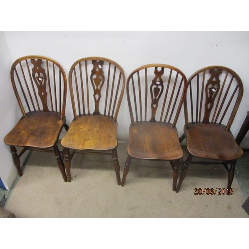 292 - A matched set of four 18th/19th century fruitwood, ash and elm Windsor chairs, each having a pierced... 