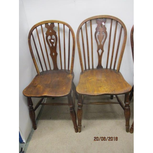 292 - A matched set of four 18th/19th century fruitwood, ash and elm Windsor chairs, each having a pierced... 