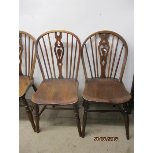 292 - A matched set of four 18th/19th century fruitwood, ash and elm Windsor chairs, each having a pierced... 