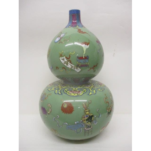 295 - A 19th century Chinese Celadon glazed, double gourd vase decorated with fruit, a vase, a dog, boxes,... 