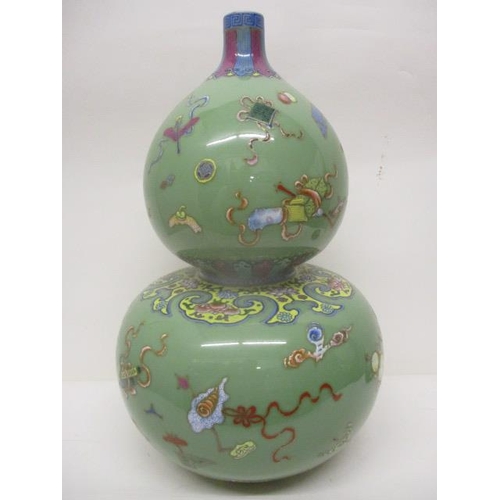 295 - A 19th century Chinese Celadon glazed, double gourd vase decorated with fruit, a vase, a dog, boxes,... 