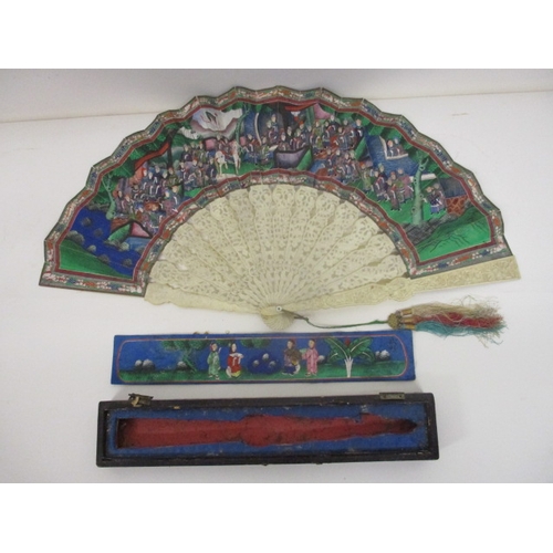 296 - A 19th century Chinese Canton ivory and painted paper fan, with carved gardes and pierced sticks, de... 