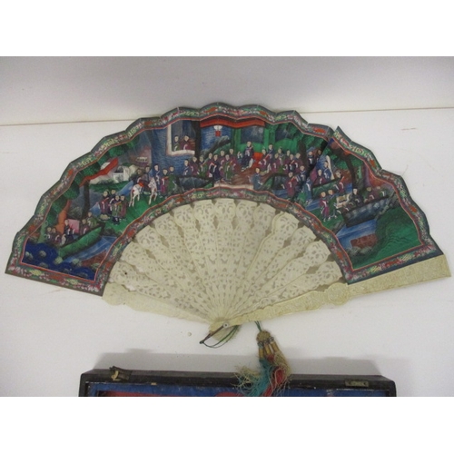 296 - A 19th century Chinese Canton ivory and painted paper fan, with carved gardes and pierced sticks, de... 