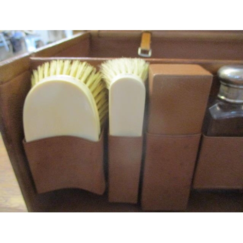 99 - A 1930s brown leather gentleman's fitted suitcase with locks, a buckled, fold over panel to the lid ... 