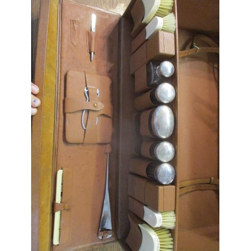 99 - A 1930s brown leather gentleman's fitted suitcase with locks, a buckled, fold over panel to the lid ... 