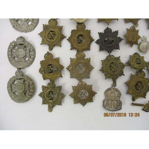 121 - Fifty mainly military cap badges to include a large number of Royal Army Service Corp, The Rifle Bri... 