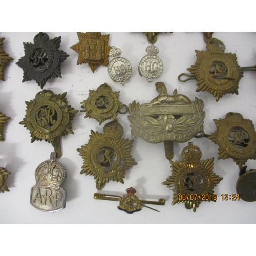 121 - Fifty mainly military cap badges to include a large number of Royal Army Service Corp, The Rifle Bri... 