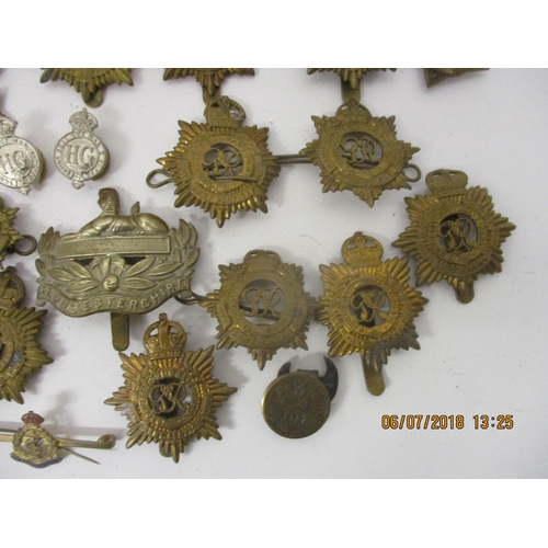 121 - Fifty mainly military cap badges to include a large number of Royal Army Service Corp, The Rifle Bri... 