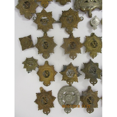 121 - Fifty mainly military cap badges to include a large number of Royal Army Service Corp, The Rifle Bri... 