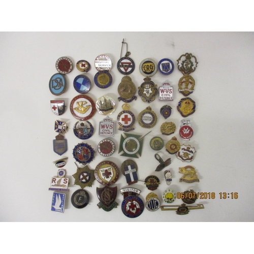 123 - Fifty Military and other enamelled and metal badges to include WVS Civil Defence, Australian Branch ... 