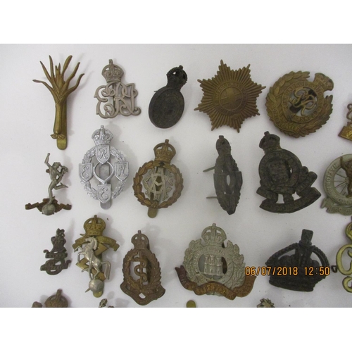 125 - Fifty military badges to include Fusiliers, Royal Army Medical Corps, Royal Canadian Engineers and o... 