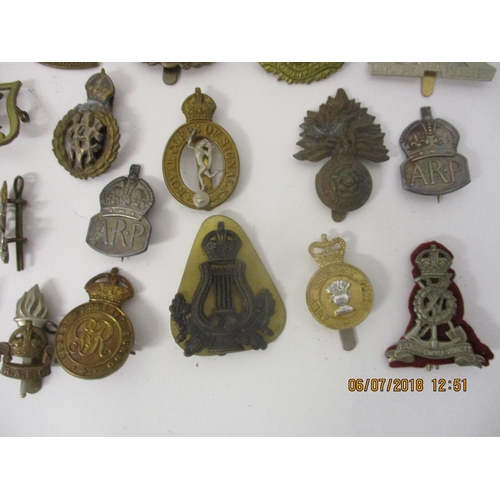 125 - Fifty military badges to include Fusiliers, Royal Army Medical Corps, Royal Canadian Engineers and o... 