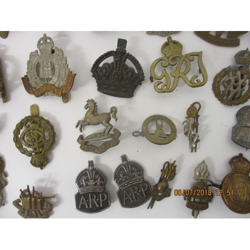 125 - Fifty military badges to include Fusiliers, Royal Army Medical Corps, Royal Canadian Engineers and o... 