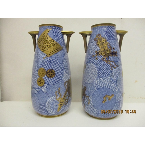 128 - A pair of late 19th century Royal Worcester china vases of ovoid form with angular handles, decorate... 