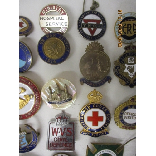 123 - Fifty Military and other enamelled and metal badges to include WVS Civil Defence, Australian Branch ... 