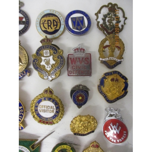 123 - Fifty Military and other enamelled and metal badges to include WVS Civil Defence, Australian Branch ... 