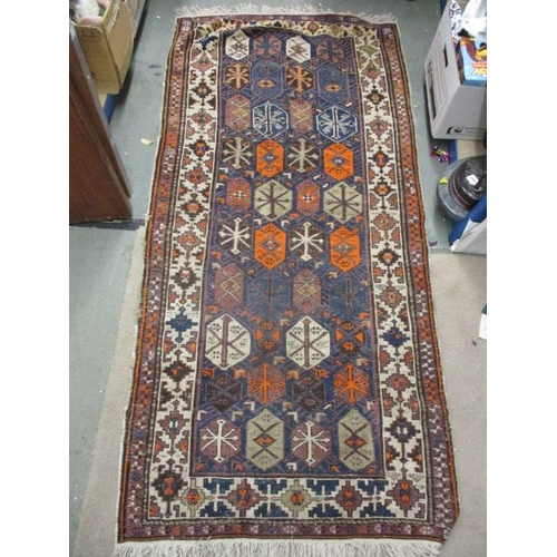 112 - A Turkish rug with octagonal panels and arrow motifs, on a blue ground, 80