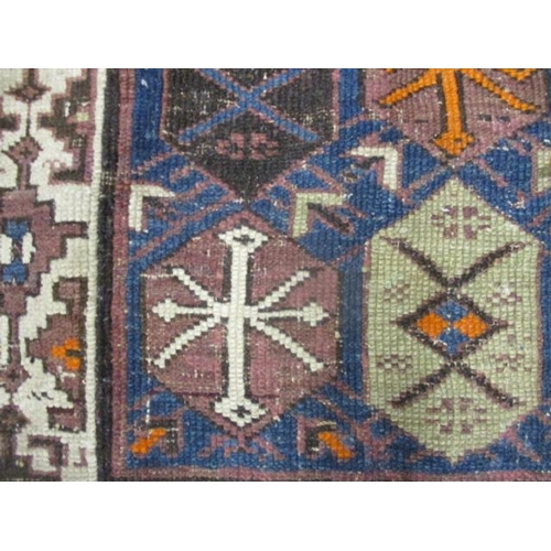 112 - A Turkish rug with octagonal panels and arrow motifs, on a blue ground, 80