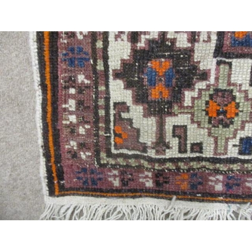 112 - A Turkish rug with octagonal panels and arrow motifs, on a blue ground, 80