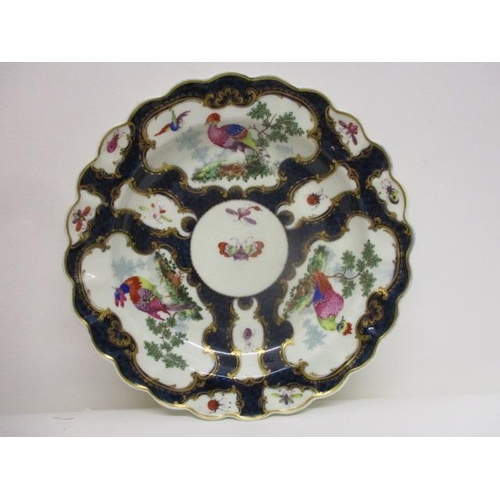 72 - A late 18th century Worcester plate with a lobed edge decoration, with vase and cartouche shaped pan... 